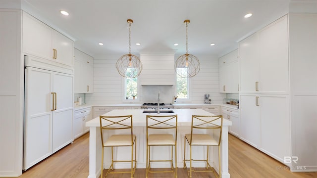 140 S Mcgregor Ave # E, Mobile, AL 36608 - kitchen featuring built in refrigerator, light wood-style floors, backsplash, light countertops, and recessed lighting