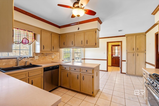 kitchen with plenty of natural light, kitchen peninsula, sink, and appliances with stainless steel finishes