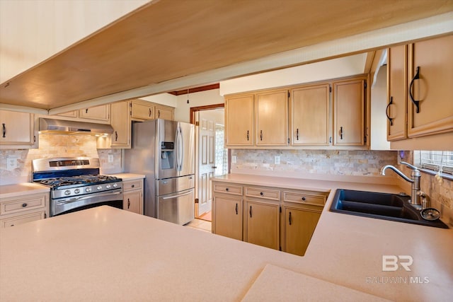 kitchen featuring appliances with stainless steel finishes, tasteful backsplash, a wealth of natural light, and sink