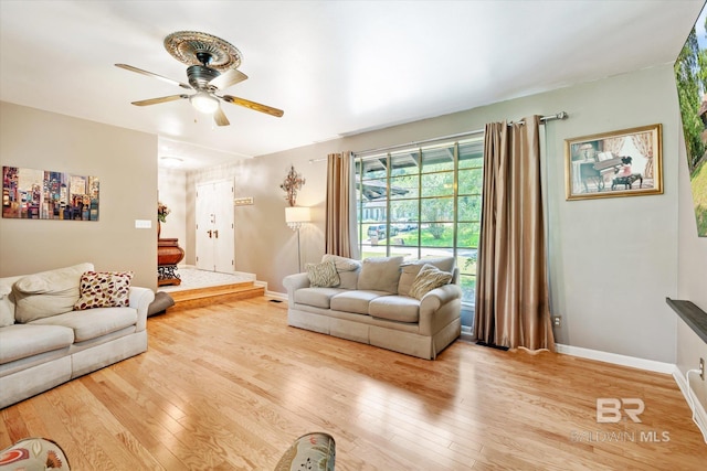 living room with ceiling fan and wood-type flooring