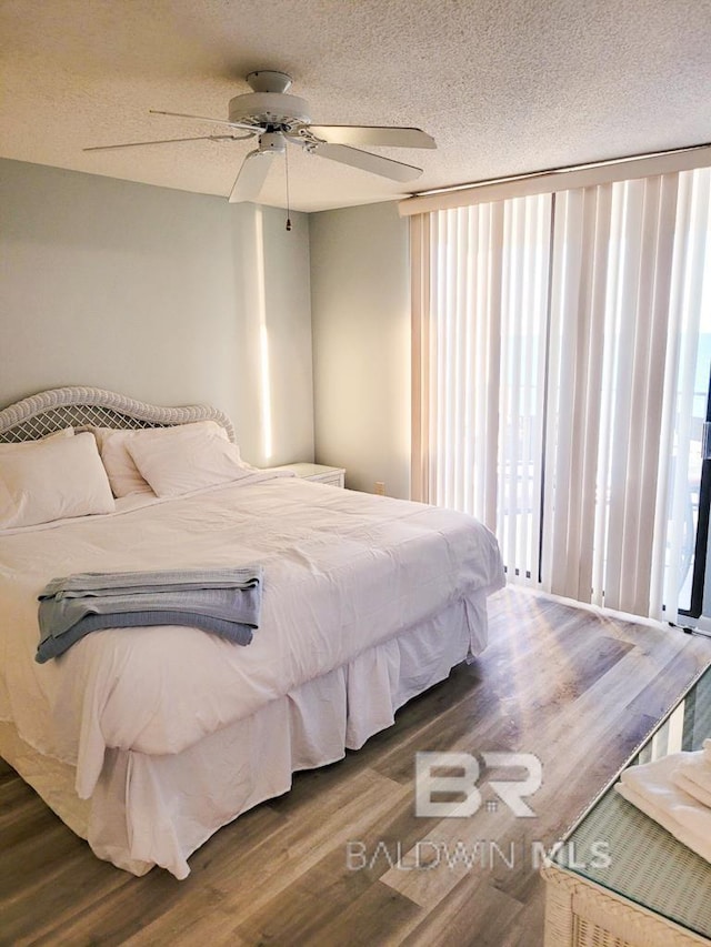 24250 Perdido Beach Blvd Unit 4603, Orange Beach, AL 36561 - bedroom featuring wood finished floors, a ceiling fan, and a textured ceiling