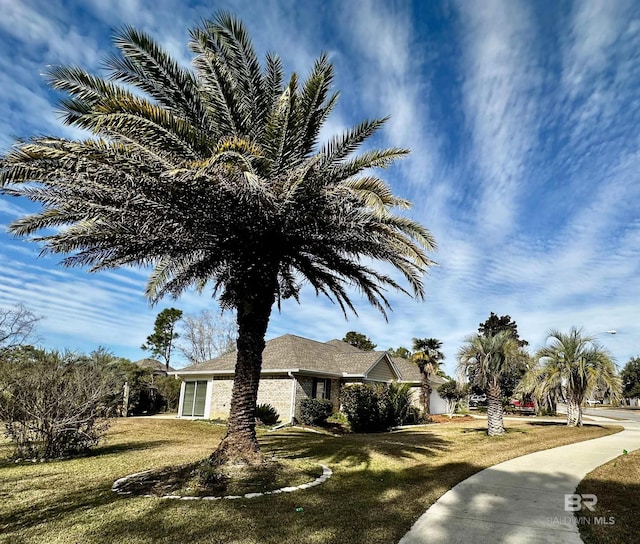 view of side of home featuring a yard