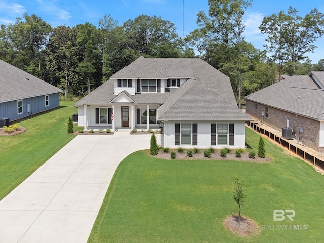 view of front of property with central AC and a front lawn