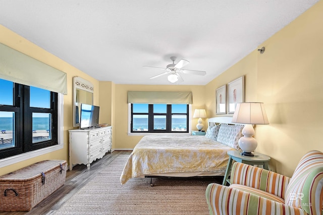 bedroom with wood-type flooring and ceiling fan