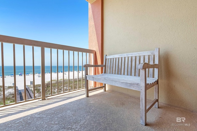 balcony with a beach view and a water view