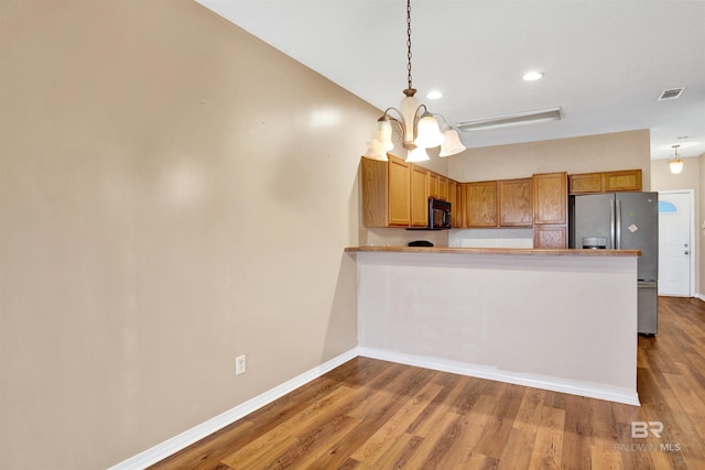 2651 S Juniper St Unit 1201, Foley, AL 36535 - kitchen with stainless steel fridge, black microwave, baseboards, wood finished floors, and recessed lighting