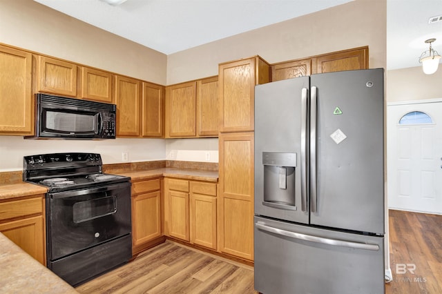 2651 S Juniper St Unit 1201, Foley, AL 36535 - kitchen with black appliances, light wood-style flooring, and light countertops