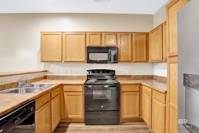 2651 S Juniper St Unit 1201, Foley, AL 36535 - kitchen with black appliances, a sink, light wood-style flooring, light brown cabinets, and light countertops