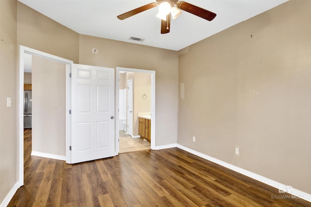 2651 S Juniper St Unit 1201, Foley, AL 36535 - unfurnished bedroom with wood finished floors, baseboards, stainless steel fridge, ensuite bathroom, and a ceiling fan