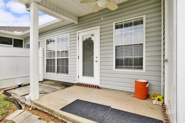 2651 S Juniper St Unit 1201, Foley, AL 36535 - view of exterior entry featuring a ceiling fan, a patio area, and fence