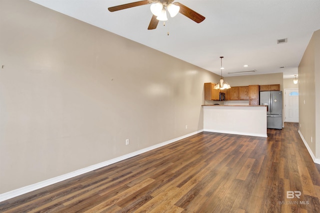 2651 S Juniper St Unit 1201, Foley, AL 36535 - unfurnished living room featuring dark wood-style floors, baseboards, ceiling fan, and a chandelier