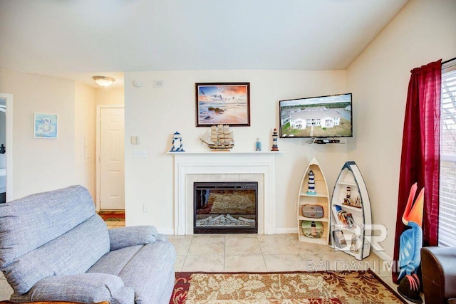 tiled living room featuring lofted ceiling and a tile fireplace