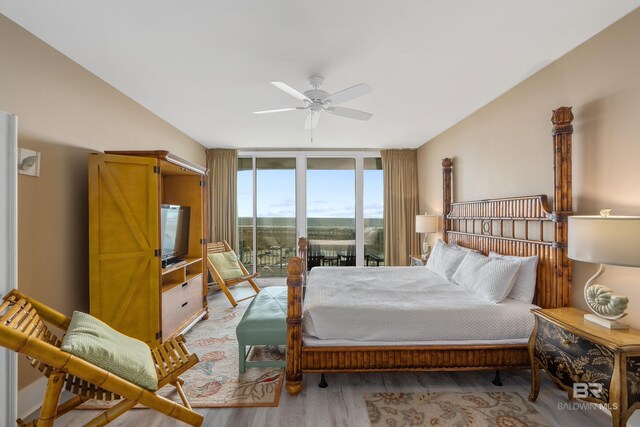 bedroom featuring hardwood / wood-style floors, access to exterior, and ceiling fan