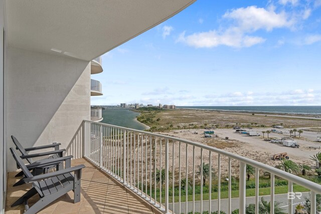 balcony featuring a water view and a view of the beach