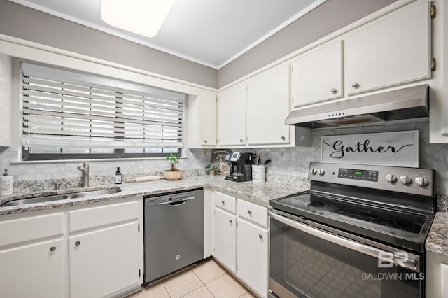 kitchen featuring white cabinets, backsplash, light tile patterned floors, stainless steel appliances, and sink