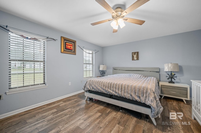 bedroom with dark hardwood / wood-style flooring and ceiling fan