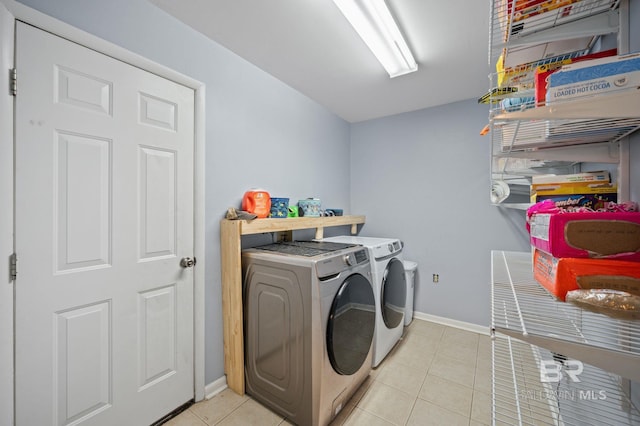 laundry room featuring separate washer and dryer and light tile patterned flooring