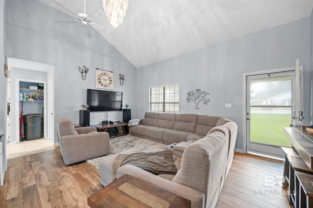 living room featuring ceiling fan, high vaulted ceiling, and light hardwood / wood-style floors