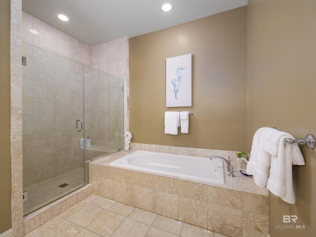 bathroom featuring tile patterned floors and separate shower and tub