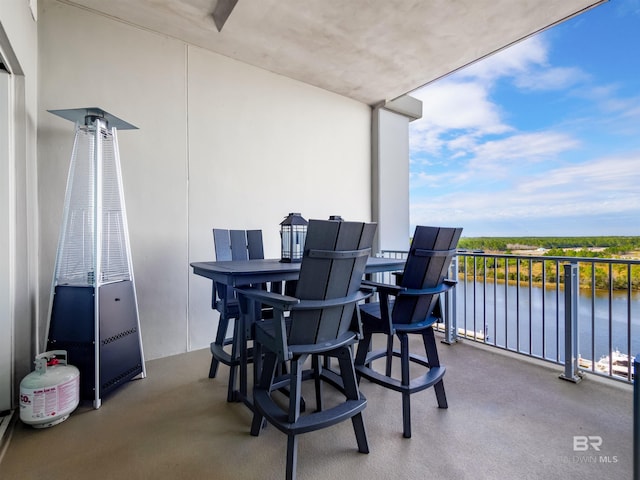 view of patio / terrace with a water view and a balcony