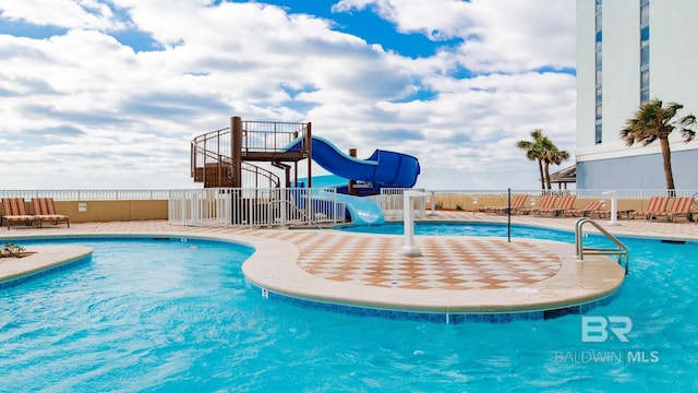 view of swimming pool with a water slide