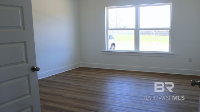 12681 Shoshoney Cir, Fairhope, AL 36532 - spare room with baseboards and dark wood-type flooring