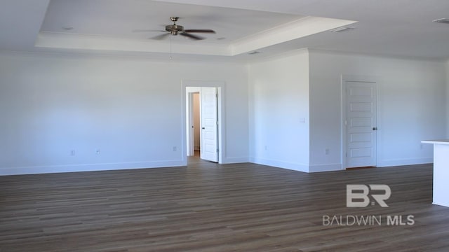 12681 Shoshoney Cir, Fairhope, AL 36532 - spare room with a raised ceiling, dark wood-type flooring, ornamental molding, ceiling fan, and baseboards