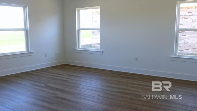 12681 Shoshoney Cir, Fairhope, AL 36532 - unfurnished room with dark wood-style flooring, plenty of natural light, and baseboards
