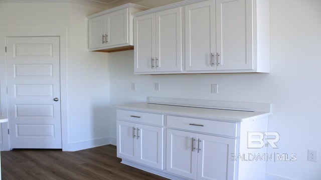 12681 Shoshoney Cir, Fairhope, AL 36532 - kitchen featuring white cabinets, light countertops, dark wood-style floors, and baseboards