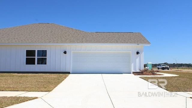 12681 Shoshoney Cir, Fairhope, AL 36532 - view of front facade featuring board and batten siding, a shingled roof, concrete driveway, an attached garage, and a front yard