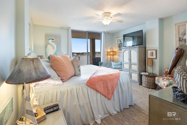 bedroom featuring floor to ceiling windows, a textured ceiling, ceiling fan, and access to exterior