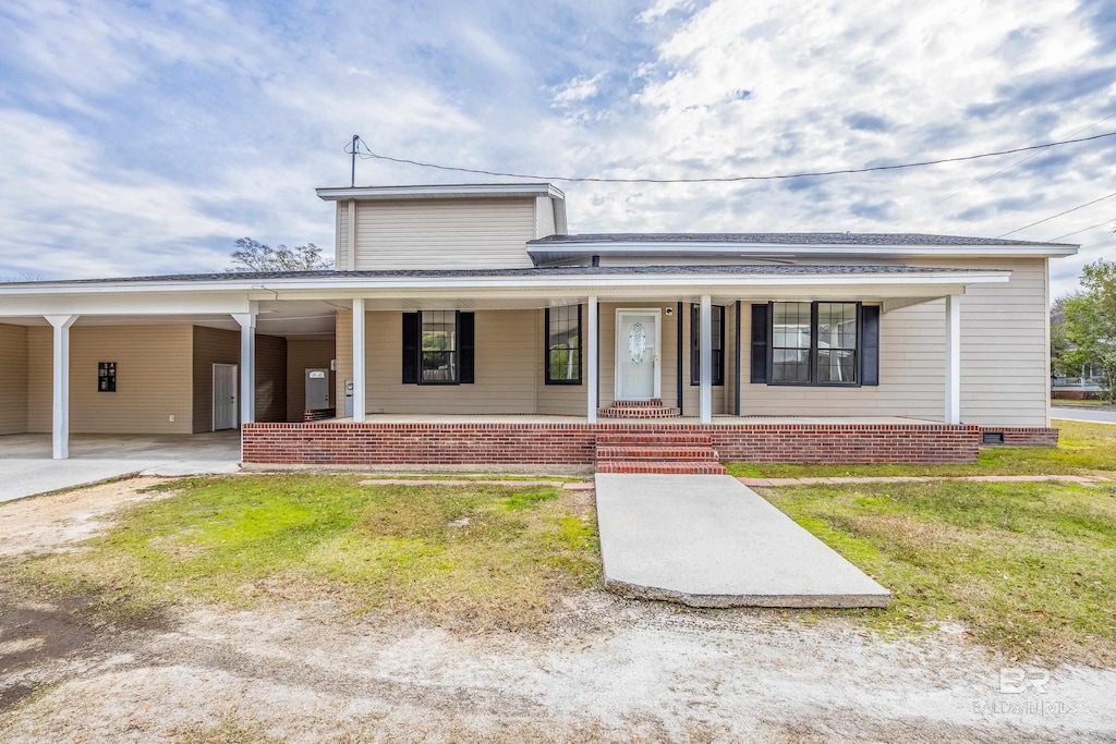 view of front of property with a porch and a carport