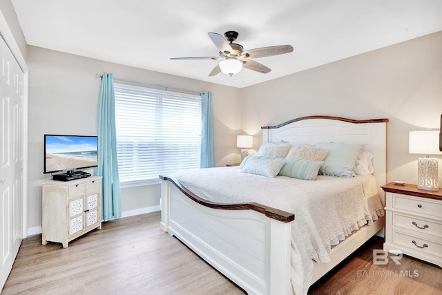 bedroom featuring ceiling fan, hardwood / wood-style floors, and a closet