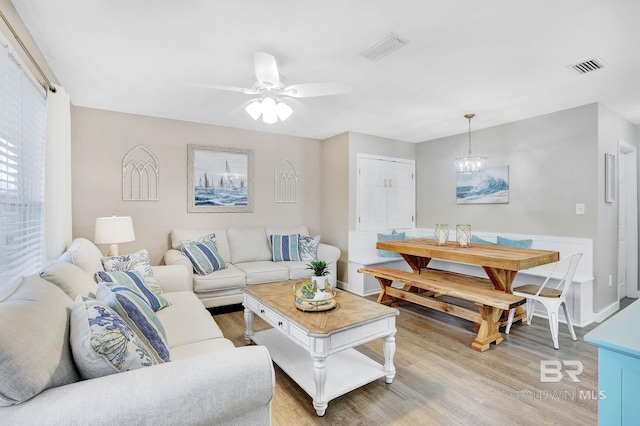 living room with ceiling fan and light hardwood / wood-style floors