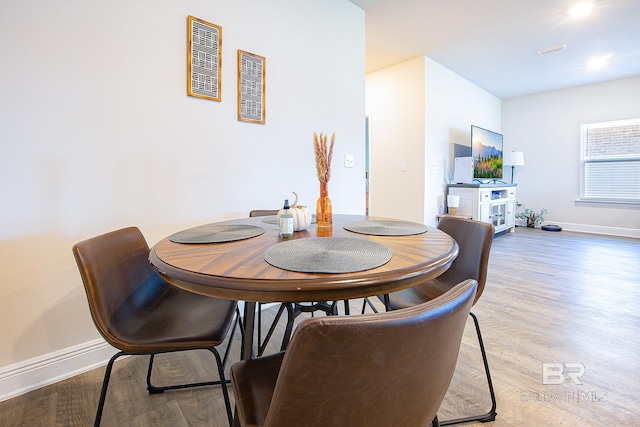 dining space featuring wood-type flooring