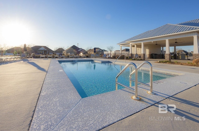 view of swimming pool with a patio and ceiling fan