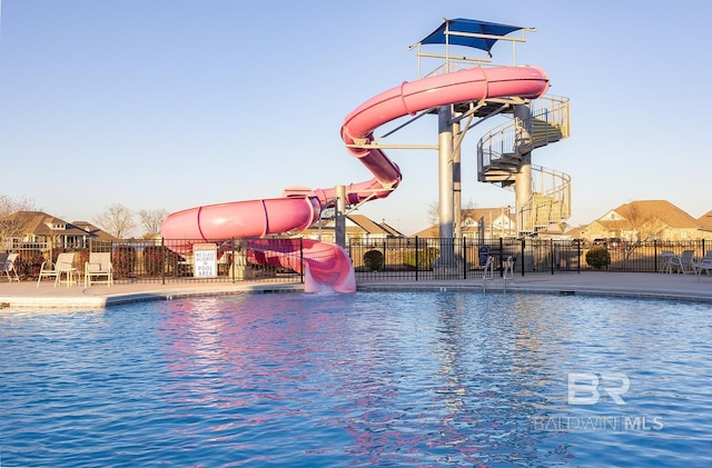 view of swimming pool with a water slide