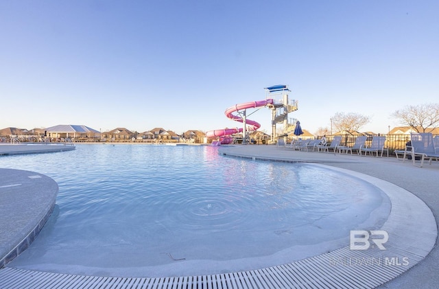 view of pool featuring a water view and a water slide