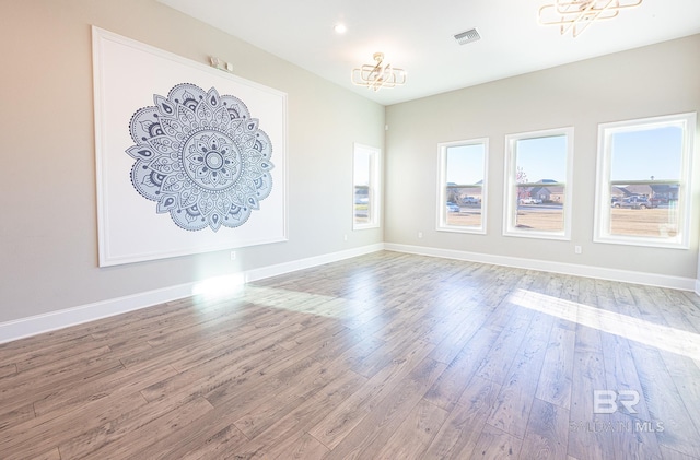 interior space with a notable chandelier and hardwood / wood-style flooring