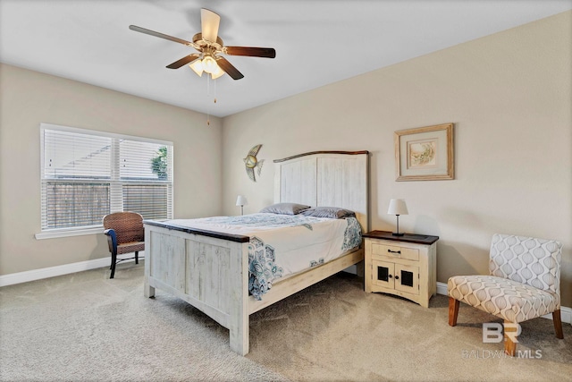 carpeted bedroom featuring baseboards and a ceiling fan