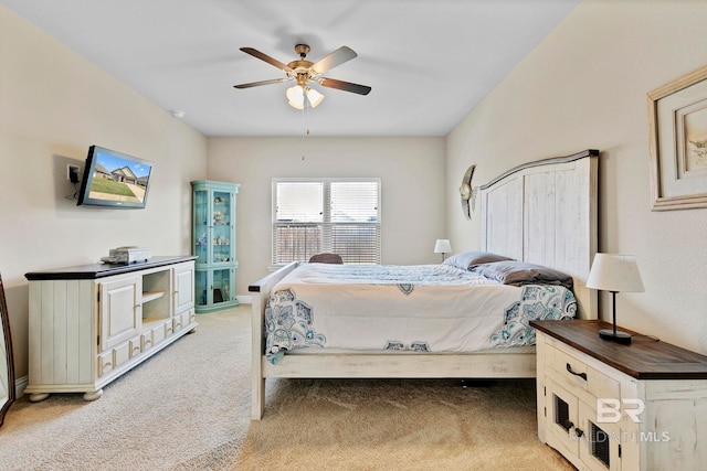 bedroom with ceiling fan and light colored carpet