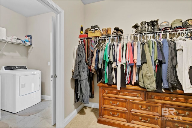 walk in closet featuring washer / dryer and light tile patterned floors