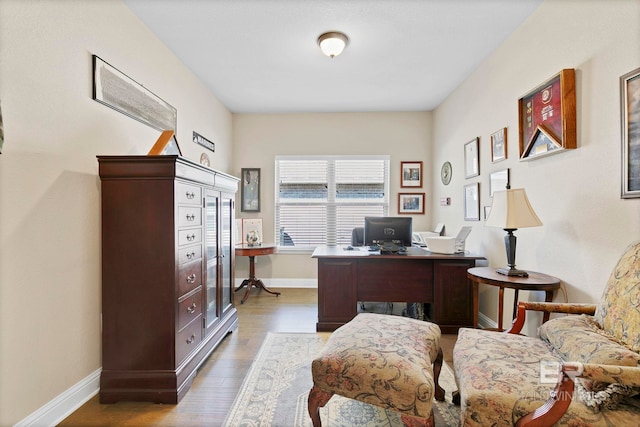 office space featuring wood finished floors and baseboards