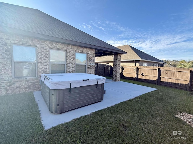 view of patio with fence and a hot tub