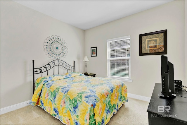 bedroom featuring carpet and baseboards