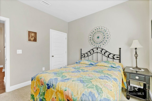 carpeted bedroom featuring visible vents and baseboards