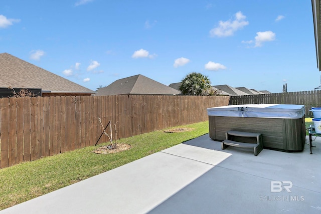 view of patio featuring a hot tub and a fenced backyard