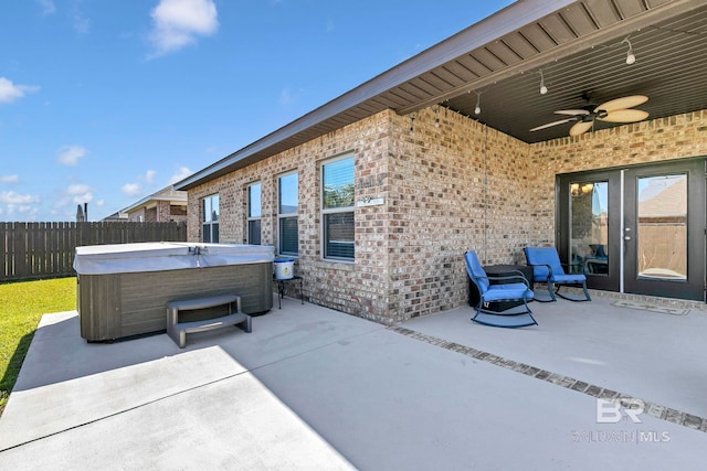 view of patio / terrace featuring a ceiling fan, a fenced backyard, and a hot tub