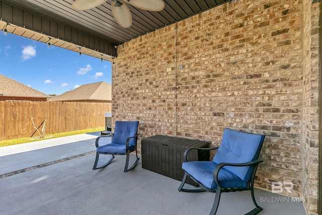 view of patio / terrace featuring ceiling fan and fence