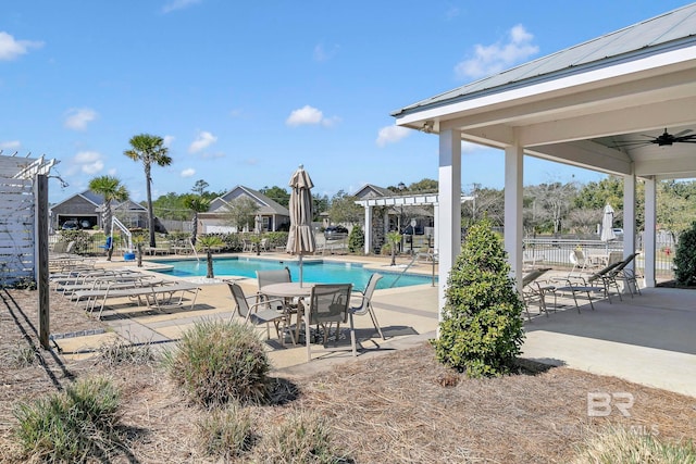 pool featuring a patio area, a ceiling fan, and a pergola